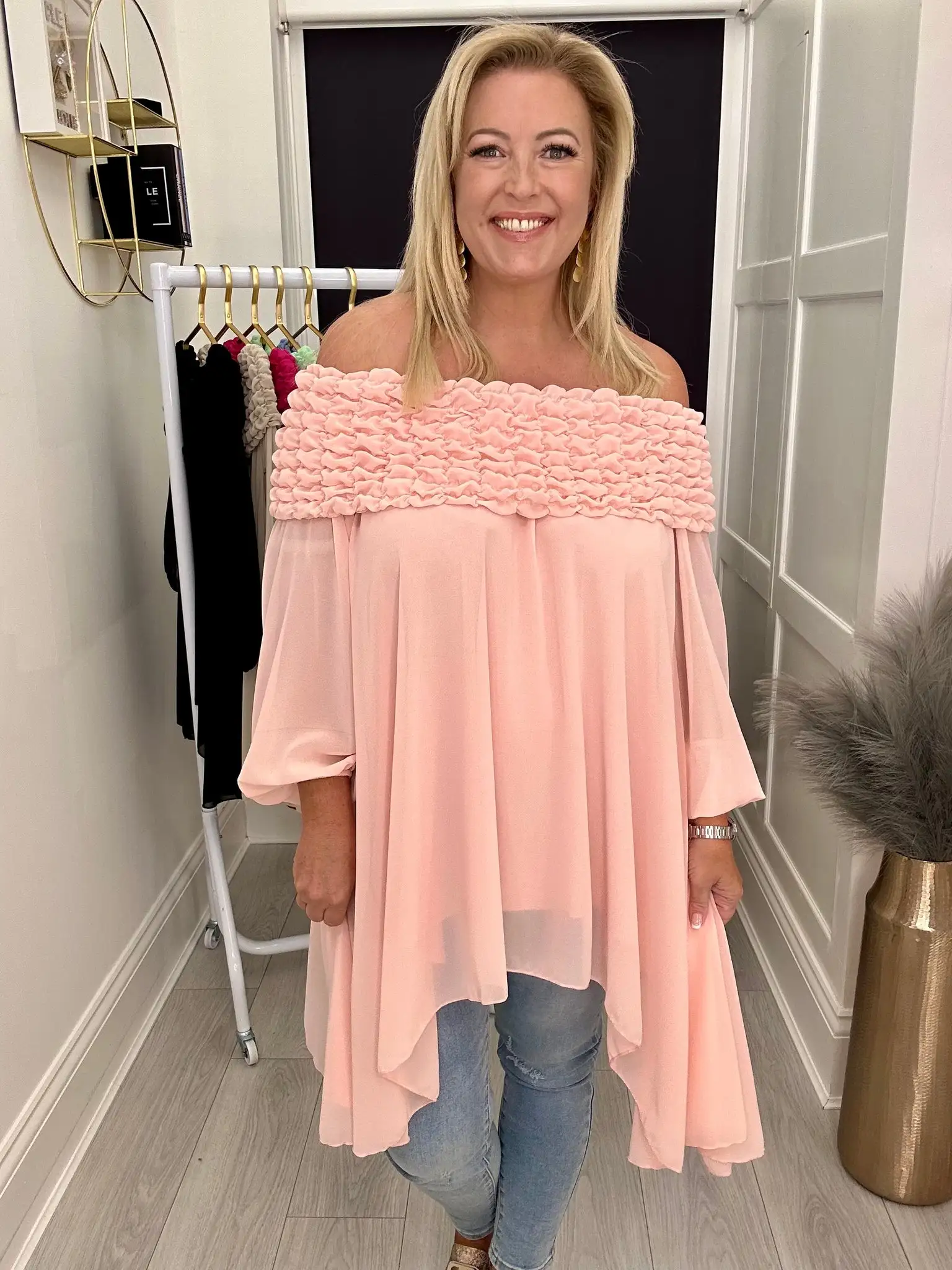 Woman in light pink off-shoulder top