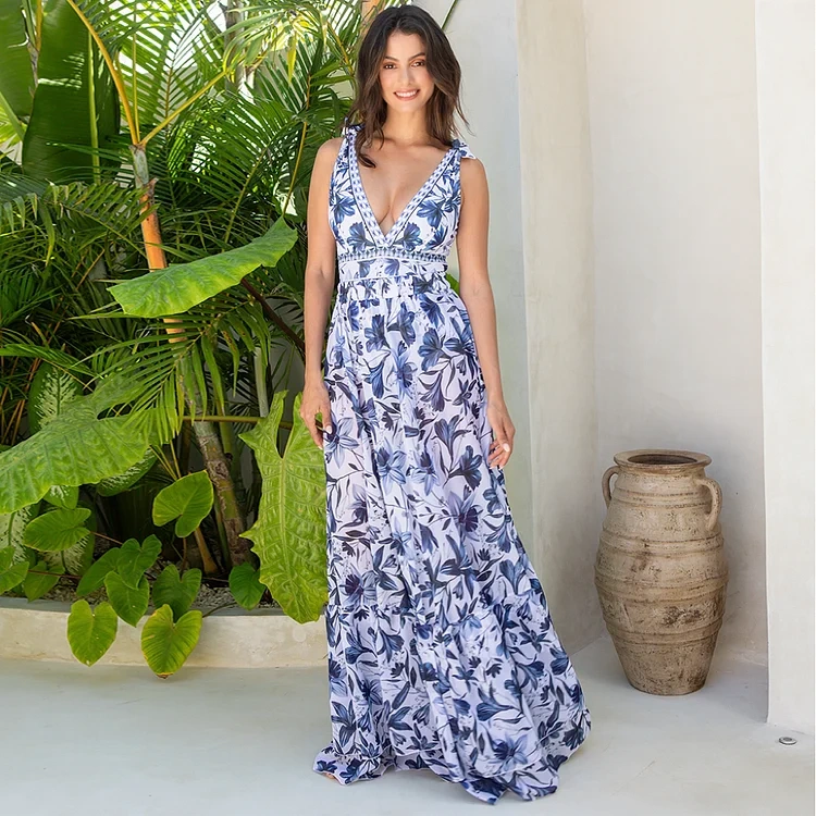 Model wearing blue floral one piece swimsuit as a maxi dress